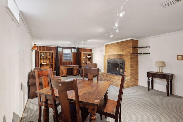 3522 Benjamin St NE, Minneapolis, MN 55418 - dining space featuring carpet floors, track lighting, a fireplace, and wooden walls