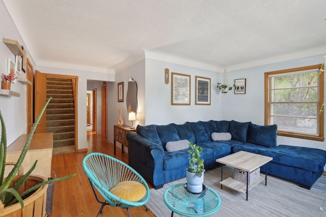 3522 Benjamin St NE, Minneapolis, MN 55418 - living area featuring a textured ceiling, wood finished floors, and stairway