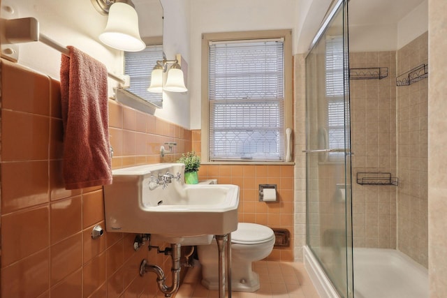 3522 Benjamin St NE, Minneapolis, MN 55418 - full bath with tile walls, a shower stall, tile patterned flooring, toilet, and a sink