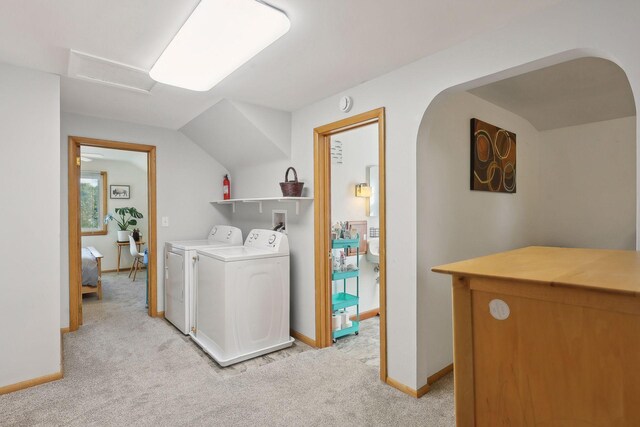 3522 Benjamin St NE, Minneapolis, MN 55418 - laundry area featuring washing machine and clothes dryer, light carpet, arched walkways, baseboards, and attic access