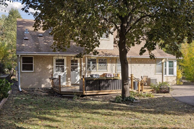 3522 Benjamin St NE, Minneapolis, MN 55418 - back of property with stucco siding, a wooden deck, a lawn, roof with shingles, and central AC