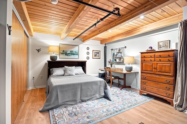 bedroom with beam ceiling, light wood-type flooring, and wood ceiling