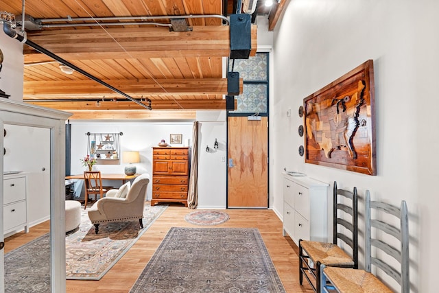 office space with rail lighting, light hardwood / wood-style flooring, and wood ceiling