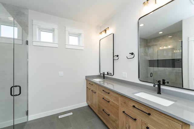 bathroom with tile patterned floors, vanity, and an enclosed shower