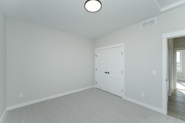 unfurnished bedroom with carpet and a closet