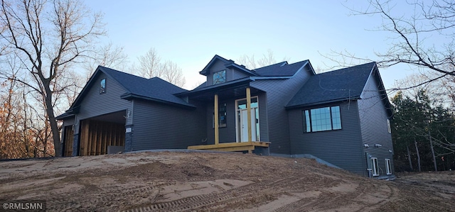 27532 Dahlia St NW, Isanti, MN 55040 - view of front facade with a garage, roof with shingles, and dirt driveway