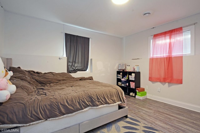 bedroom with hardwood / wood-style flooring