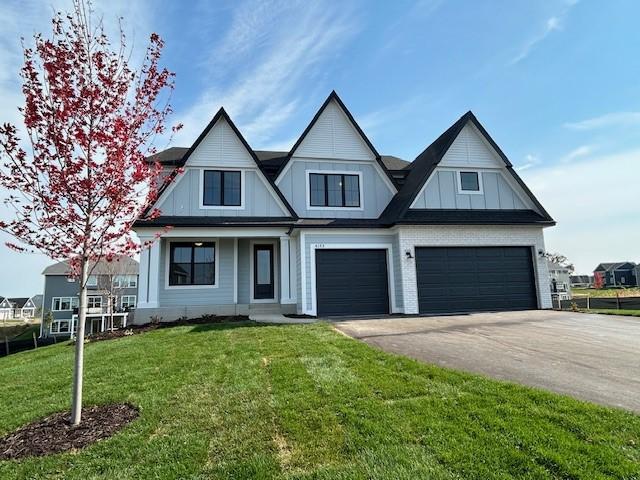 view of front of house with a front yard and a garage