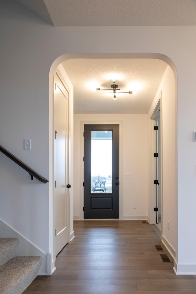 foyer with a textured ceiling and hardwood / wood-style flooring