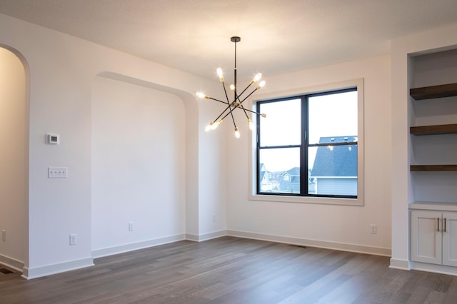 interior space with a chandelier, dark hardwood / wood-style floors, and built in shelves