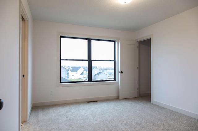 unfurnished bedroom with light colored carpet