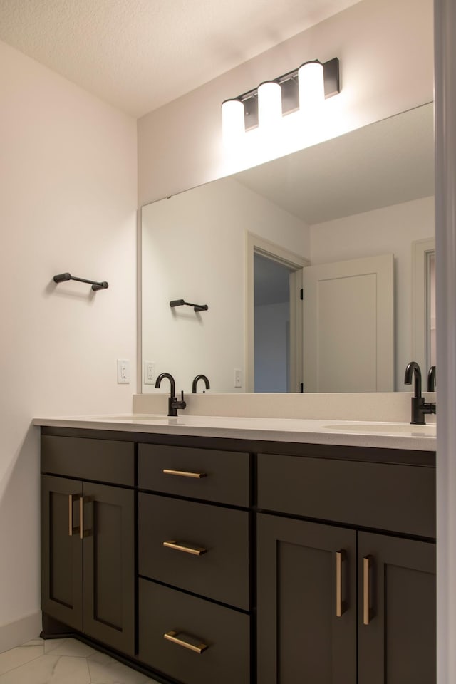 bathroom with a textured ceiling and vanity