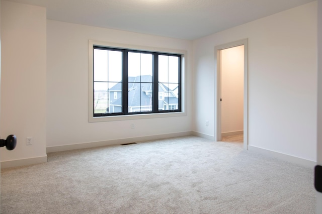 spare room with light colored carpet