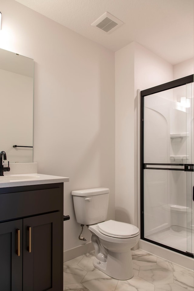 bathroom featuring toilet, walk in shower, and vanity