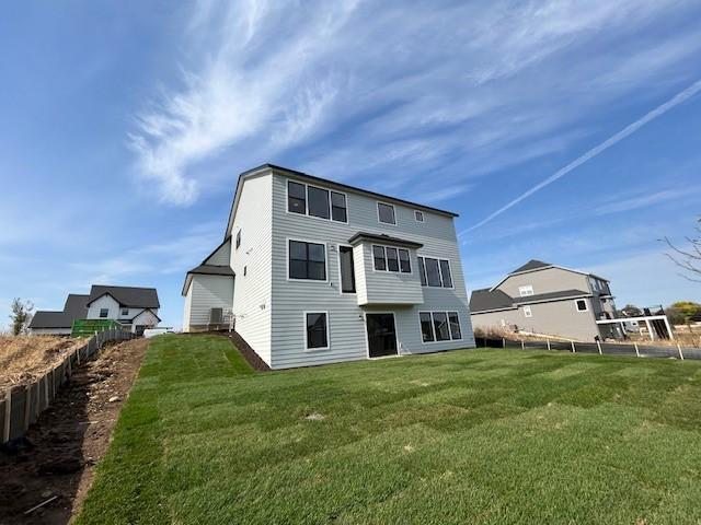 rear view of property with a yard