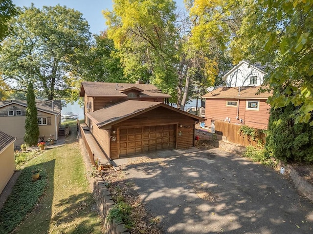 exterior space featuring fence and a detached garage