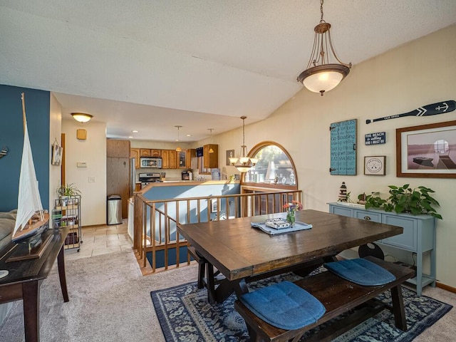 dining room with lofted ceiling, a notable chandelier, and light colored carpet