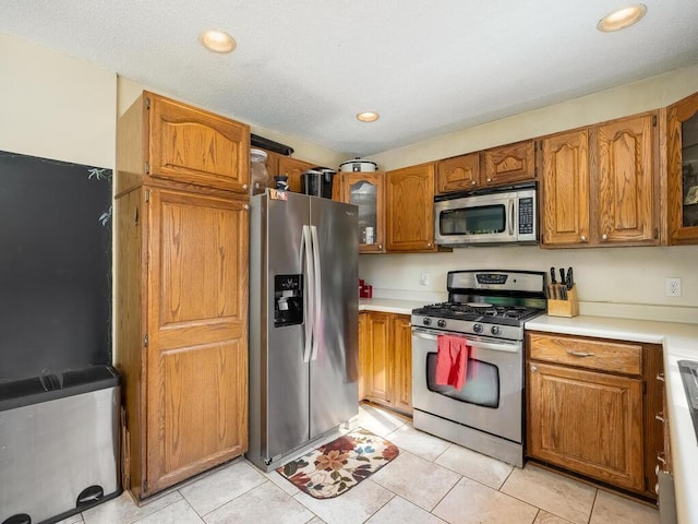 kitchen featuring stainless steel appliances and light tile patterned floors