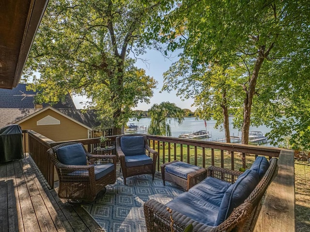 wooden terrace featuring a water view