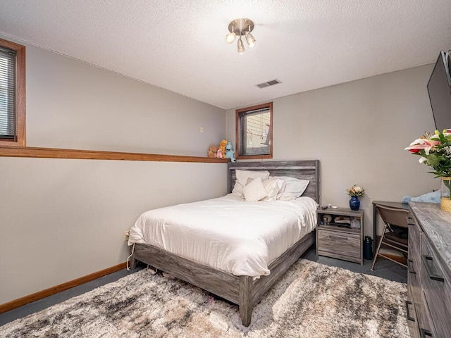 bedroom with a textured ceiling and carpet flooring