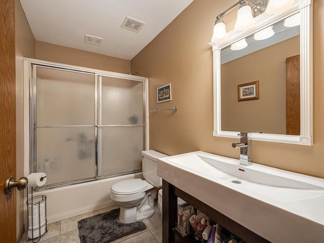 full bathroom with bath / shower combo with glass door, toilet, and vanity