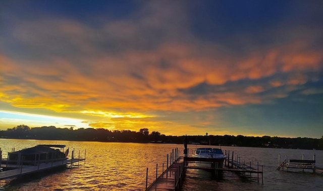 dock area featuring boat lift and a water view
