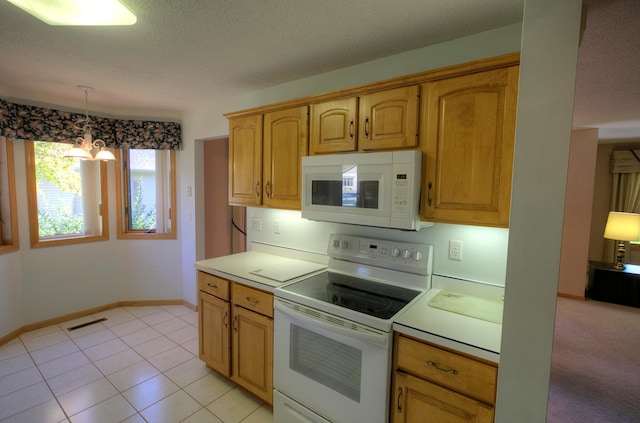 kitchen featuring a textured ceiling, pendant lighting, a chandelier, and white appliances