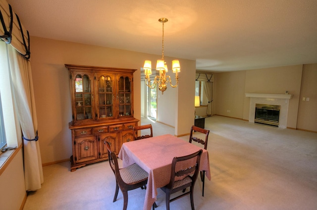 dining area featuring light carpet, a high end fireplace, and an inviting chandelier