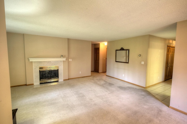 unfurnished living room featuring a fireplace, a textured ceiling, and carpet flooring