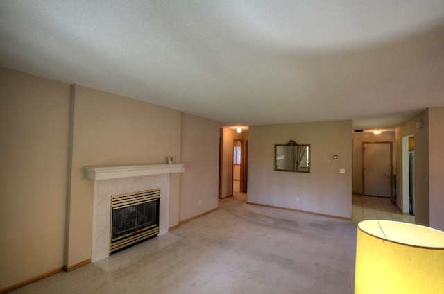 unfurnished living room with light colored carpet, a textured ceiling, and a tiled fireplace