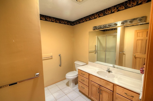 bathroom featuring tile patterned floors, vanity, toilet, and walk in shower