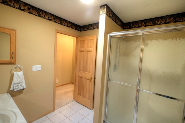 bathroom with tile patterned flooring, vanity, and a shower with door