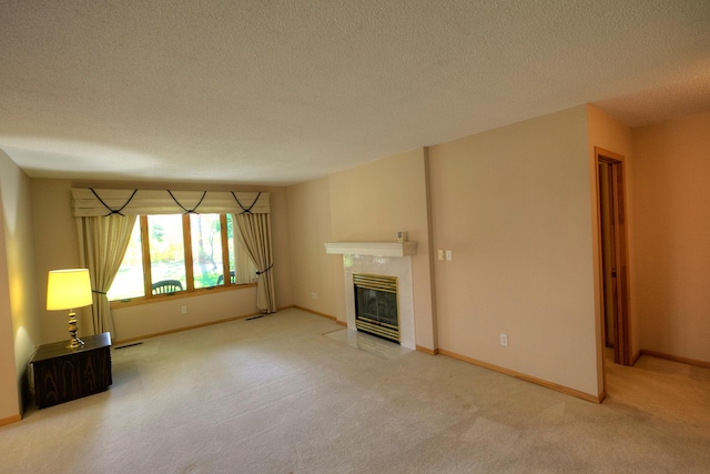 unfurnished living room featuring baseboards, a tile fireplace, carpet, and a textured ceiling