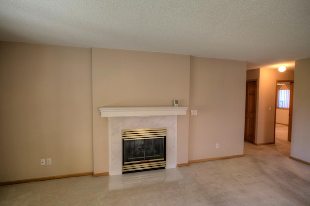 unfurnished living room featuring a textured ceiling, carpet floors, a fireplace, and baseboards