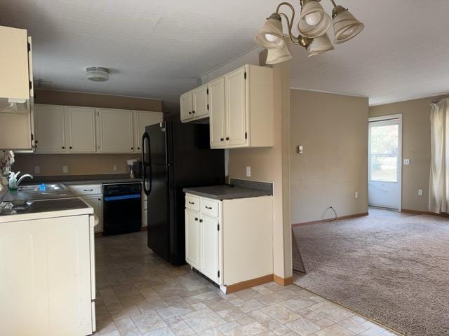 kitchen featuring black appliances, white cabinets, light carpet, sink, and an inviting chandelier