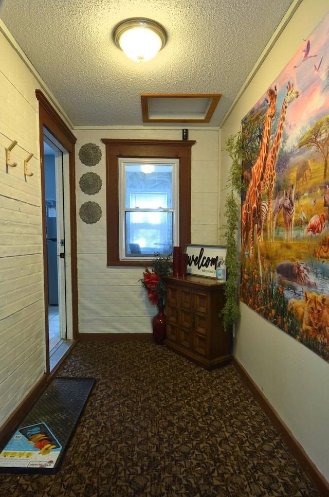 hall with a textured ceiling