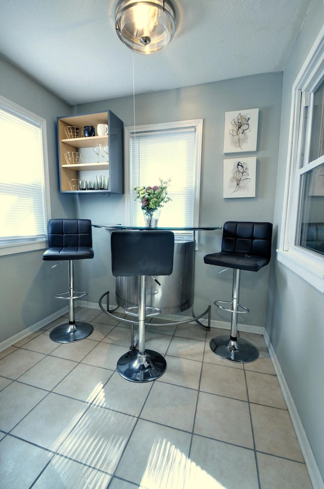 bar featuring light tile patterned flooring