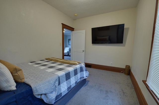 carpeted bedroom featuring a textured ceiling