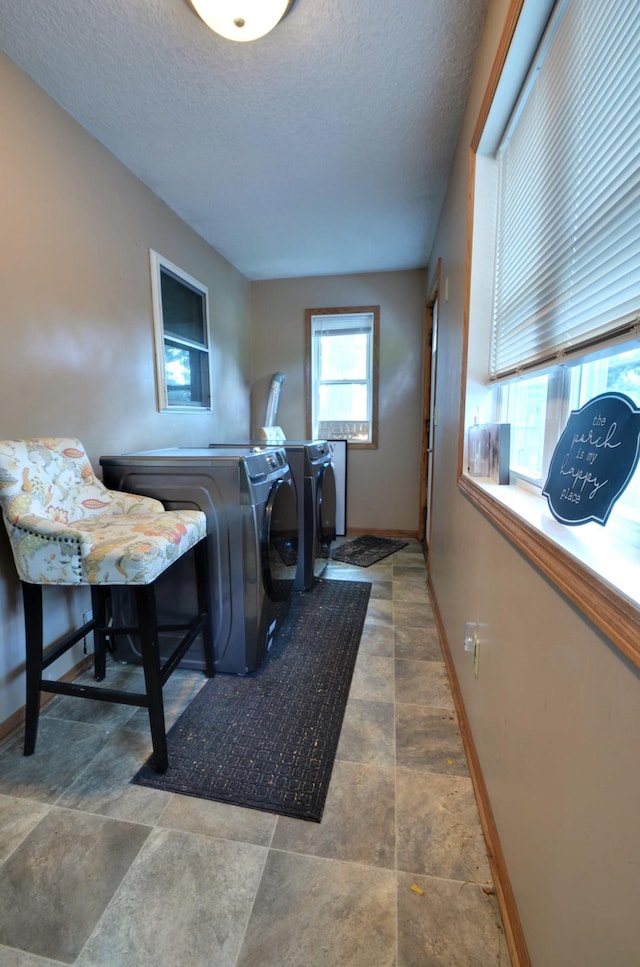 laundry room featuring independent washer and dryer and a textured ceiling