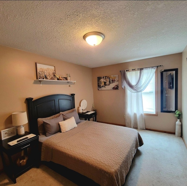 bedroom with light carpet and a textured ceiling