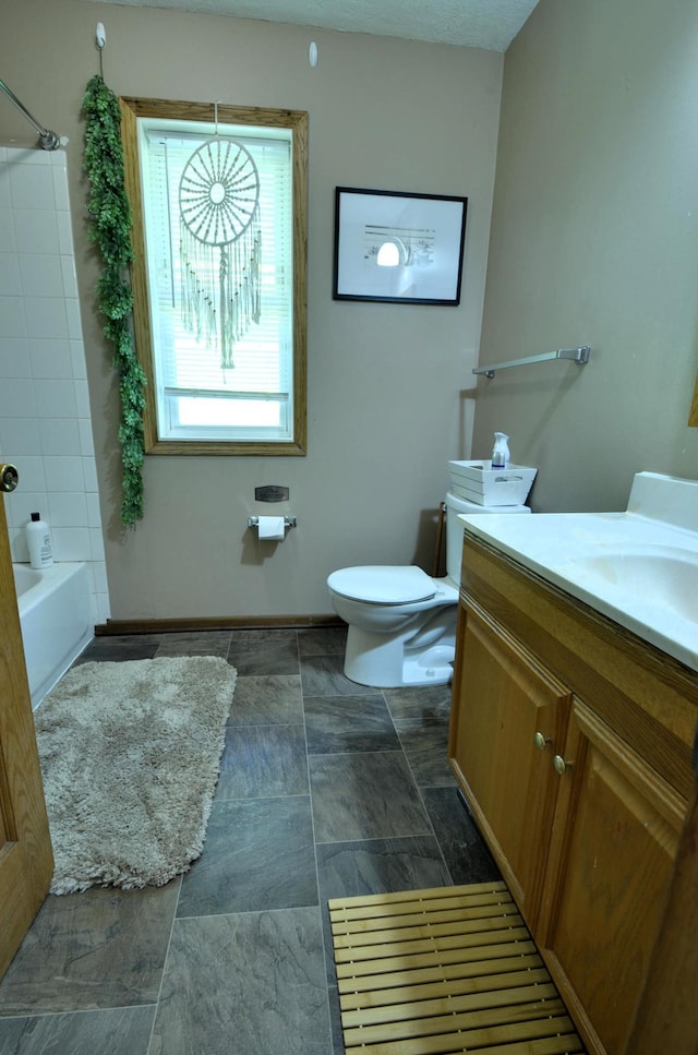 full bathroom featuring toilet, shower / tub combination, vanity, and a textured ceiling