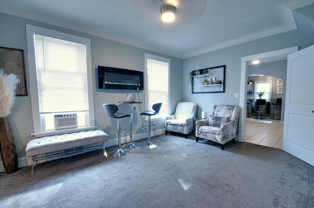 sitting room featuring ceiling fan, cooling unit, and carpet floors