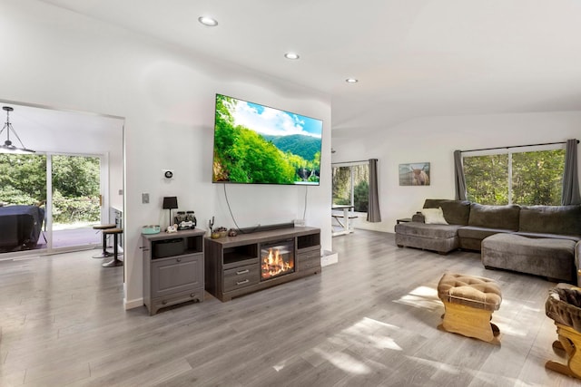 living room featuring light hardwood / wood-style flooring and lofted ceiling