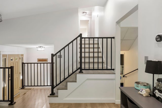 stairs with hardwood / wood-style flooring