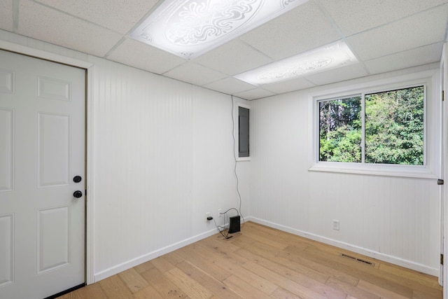 washroom featuring electric panel and light hardwood / wood-style flooring