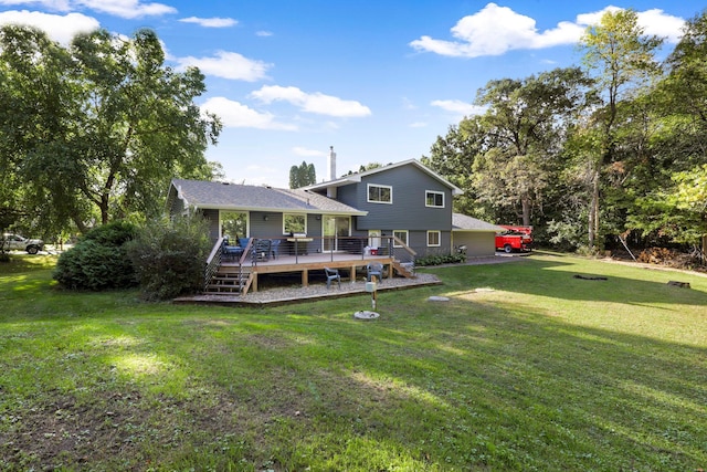 rear view of property with a lawn and a wooden deck