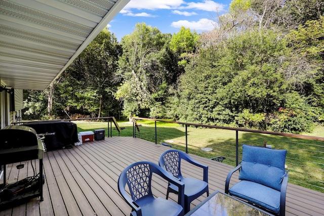 wooden deck with a lawn and area for grilling