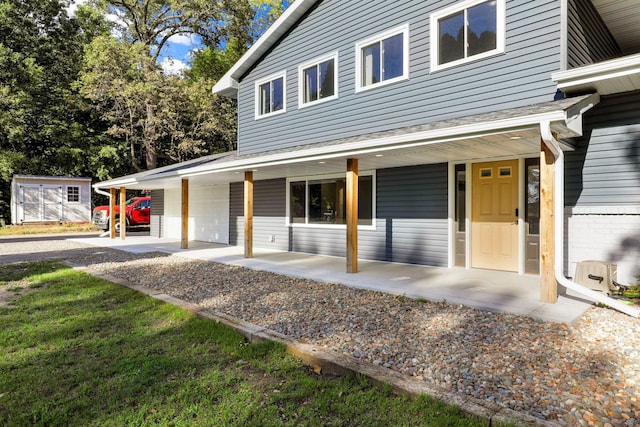 farmhouse inspired home featuring a porch and a garage