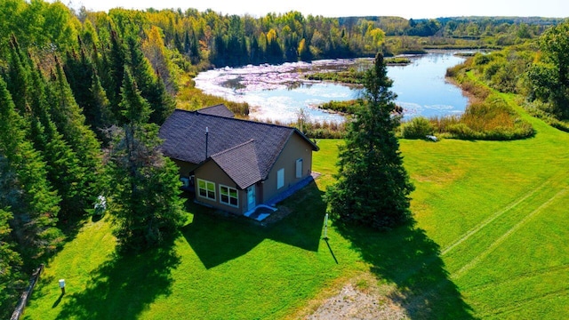 birds eye view of property featuring a water view and a view of trees