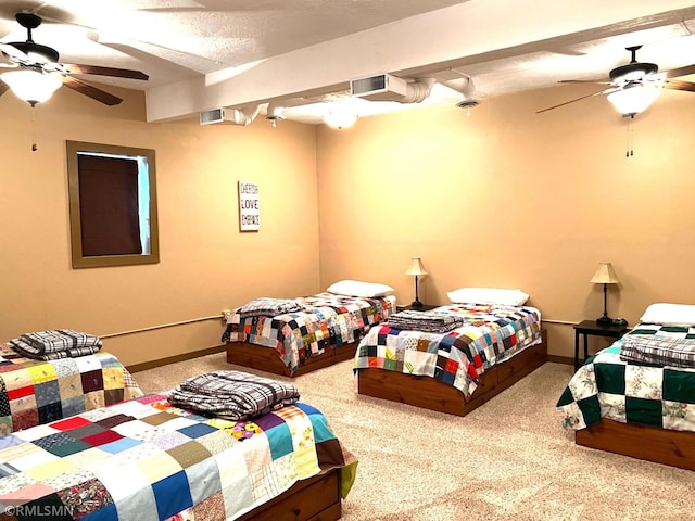 carpeted bedroom with a textured ceiling and ceiling fan